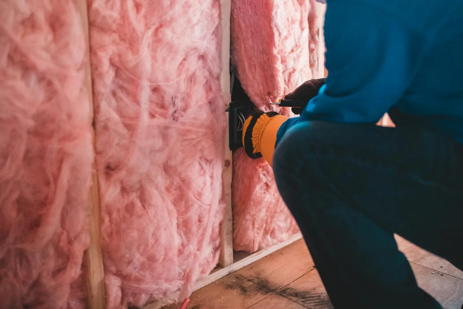 Mineral wool insulation between timber studs — loft and floor insulation are cheap ways to cut heat loss before a heat pump goes in.