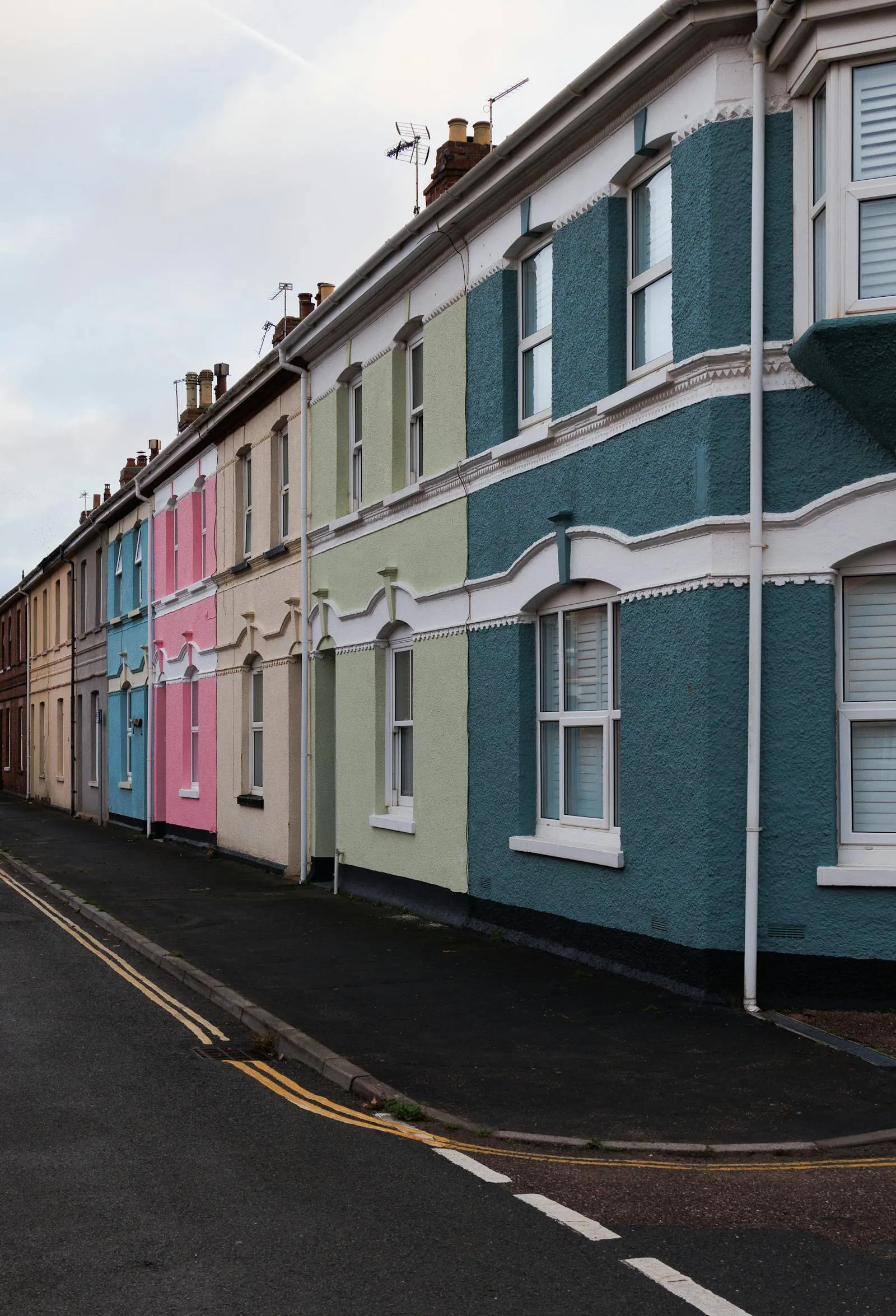 A row of painted Victorian terraced houses on a UK street — period housing stock found across Bristol-area suburbs, including parts of Westbury-on-Trym.